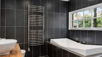 Bathtub, hair dryer, towels, soap