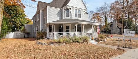 A two-story house with a porch, a flag, and a sign indicating 'The Northside'.