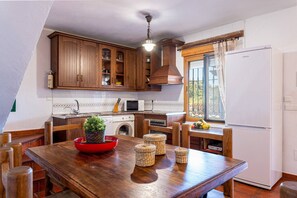 Kitchen features a central island, microwave, sink, and washing machine.