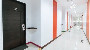 A hallway with a black door marked "30", a "VACANT" sign, and directional arrows on the floor.