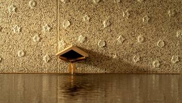 A textured wall with embedded floral designs and a wooden structure.