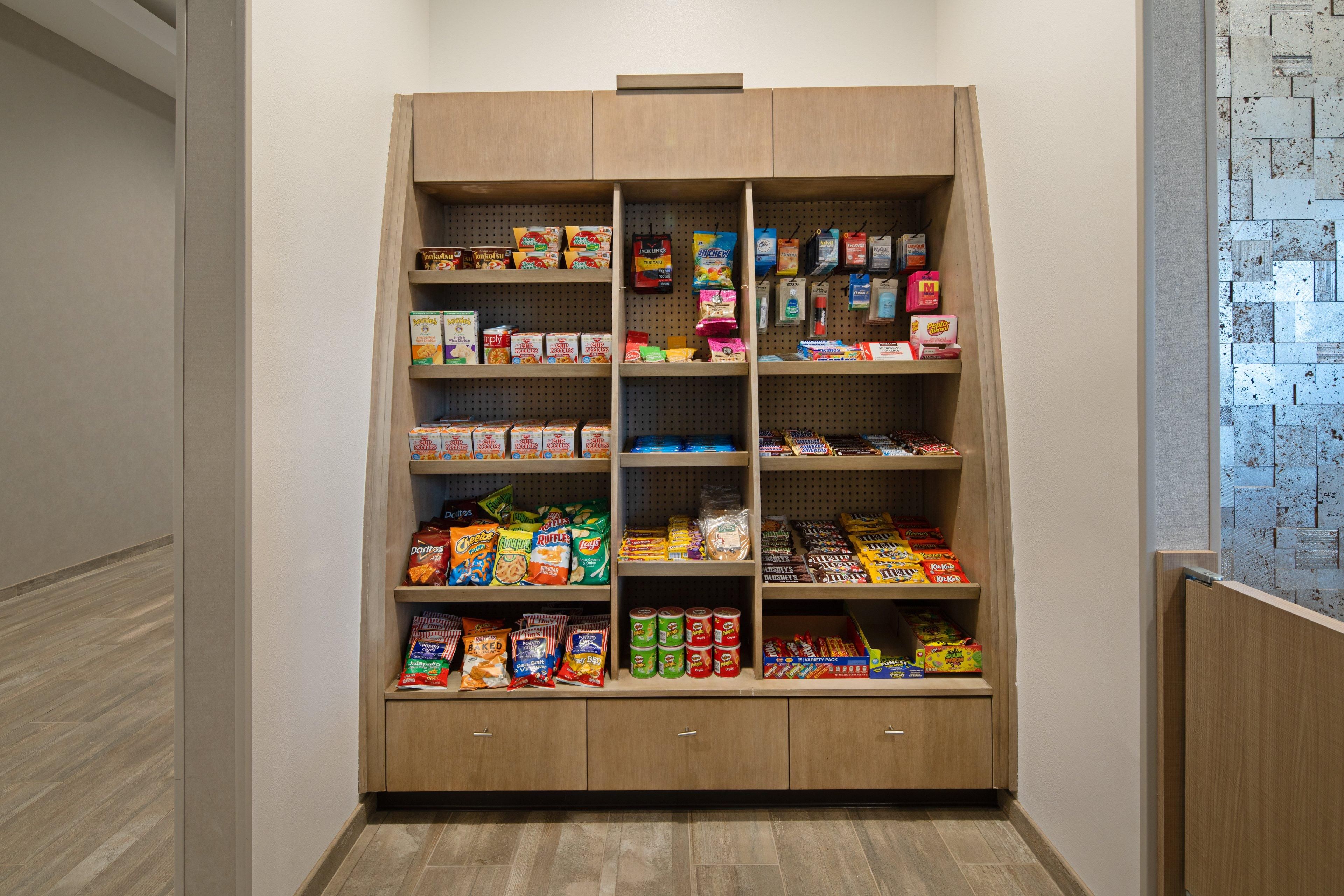 A pantry with shelves stocked with various food items.