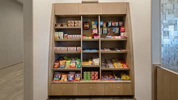 A pantry with shelves stocked with various food items.