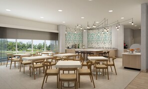 A modern dining area with multiple tables and chairs, a central island with a bar, and a view of greenery outside.