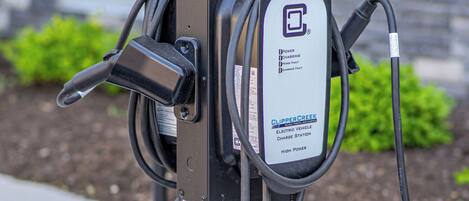 An electric vehicle charging station with a sign indicating it is for EV vehicles only.