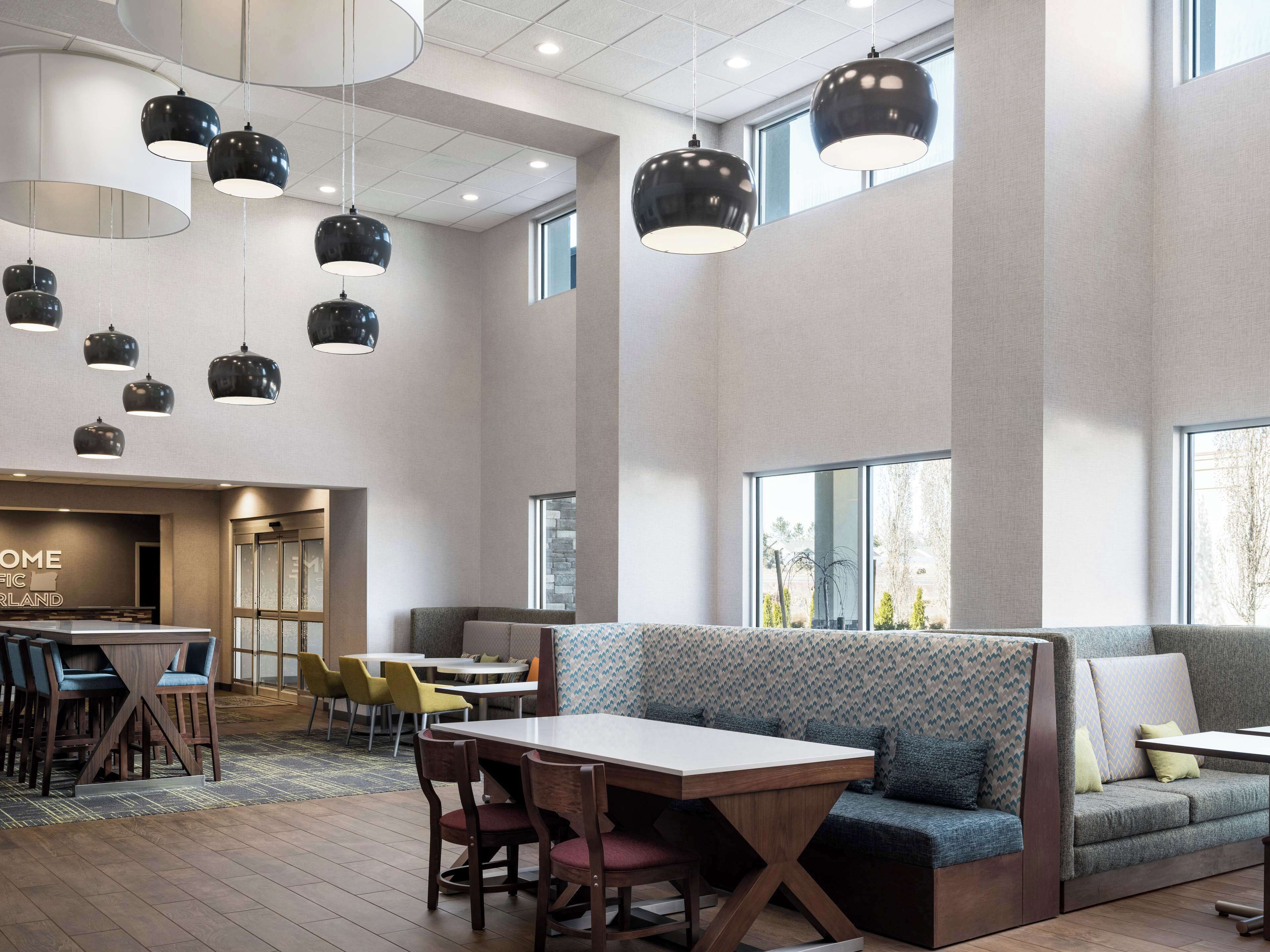 Un interior moderno con una zona de estar, un bar y una recepción.