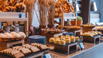 A bakery display with various breads and pastries.