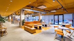 A modern interior with seating areas, tables, and large windows. - Residencia Universitaria Resa San Mamés - Campus Accomodation (Bilbao)