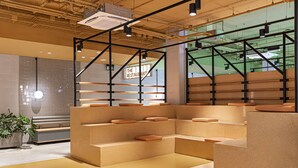 A modern interior with tiered seating and a visible sign for 'The Restaurant'. - Residencia Universitaria Resa San Mamés - Campus Accomodation (Bilbao)