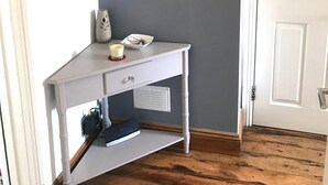A room with a white vanity, a round mirror, a telephone, a small vase, and a candle on the vanity. - Laines Loft - cosy flat in the centre of The Laines, with private sun terrace (Brighton)