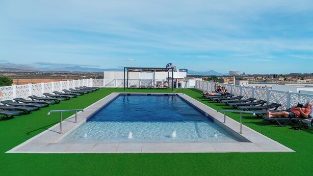 A rooftop pool with a clear view of the cityscape and mountains in the background. - Hotel AJ Gran Alacant (Santa Pola)
