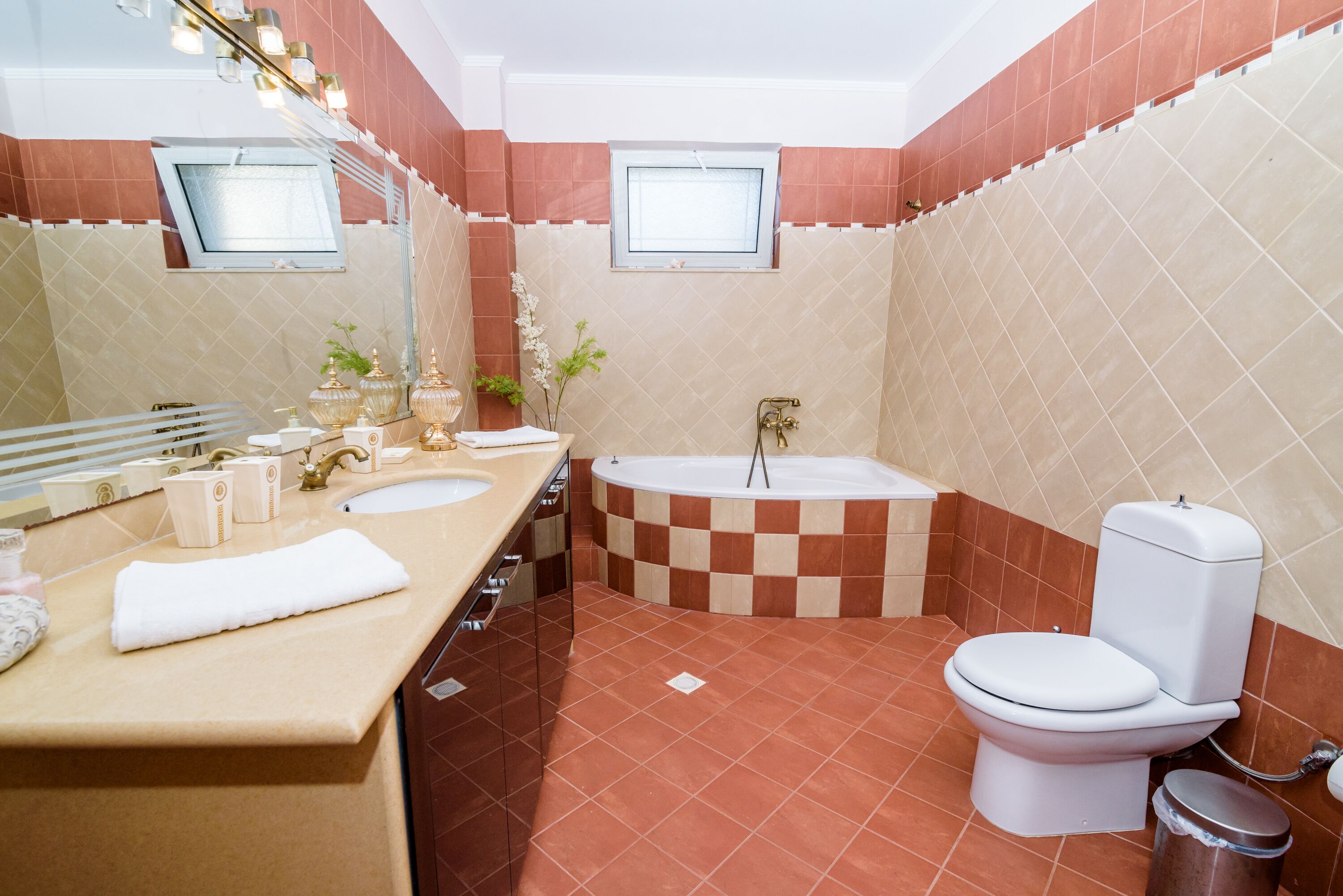 A bathroom with a bathtub, toilet, and sink.