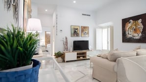 Una sala moderna con un sofá, una televisión y obras de arte en la pared.