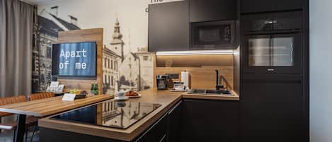 A modern kitchen with a wooden island, built-in appliances, and a cityscape mural.