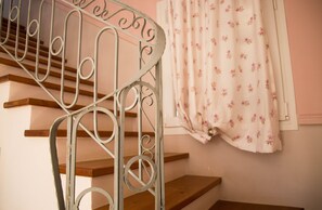 A staircase with metal railings and wooden steps.
