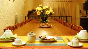 A long dining table with chairs, a vase of flowers, and various dishes and utensils. - Ancient Rural Tower in Tuscia Area, Near Viterbo Italy (Vignanello)