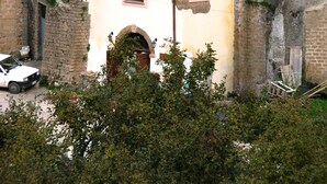 A multi-story building with a tiled roof, a white facade, and multiple windows. - Ancient Rural Tower in Tuscia Area, Near Viterbo Italy (Vignanello)