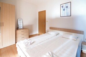 Apartment, 1 Bedroom, Balcony | 1 bedroom, iron/ironing board, bed sheets