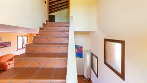 A staircase with patterned steps leading to a wooden ceiling. - 1905 Villa Artas (Tuglie)