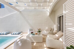 A modern outdoor living area with a pool, white furniture, and a pergola. - 1962 La Giada (Maruggio)