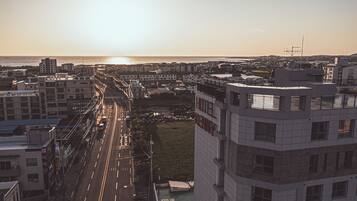 A hotel with a view of the sea and a busy road.