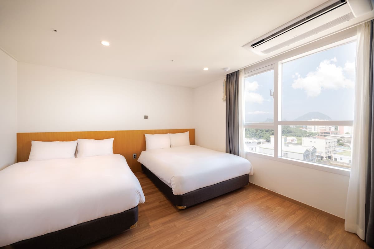 deluxe quadruple room, 2 double beds | premium bedding, down duvets, desk, laptop workspace