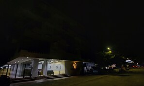 Un bâtiment moderne avec une façade en verre et un logo sur le côté.