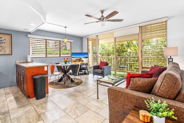 A modern living room with a sofa, coffee table, and dining area.
