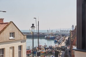 A harbor with boats docked, a lighthouse in the background, and a building labeled "Eastborough."