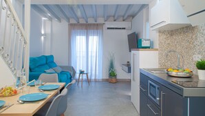 Eine moderne Küche mit Spüle, Arbeitsfläche und Essbereich mit Tisch für zwei Personen.