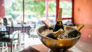 A bar area with a bowl of champagne bottles and ice.