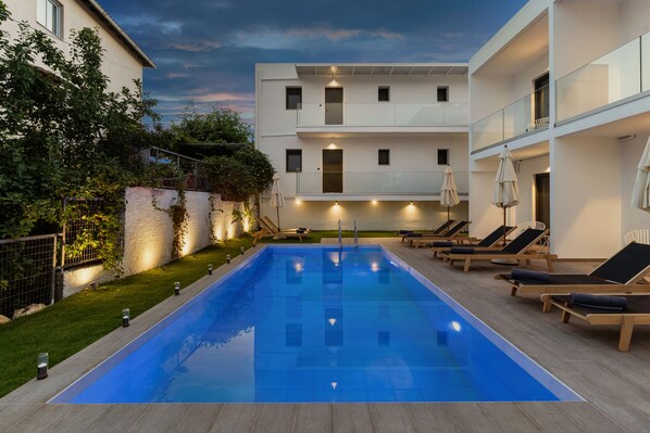 Seasonal outdoor pool, open 10:00 AM to 7:00 PM, pool umbrellas