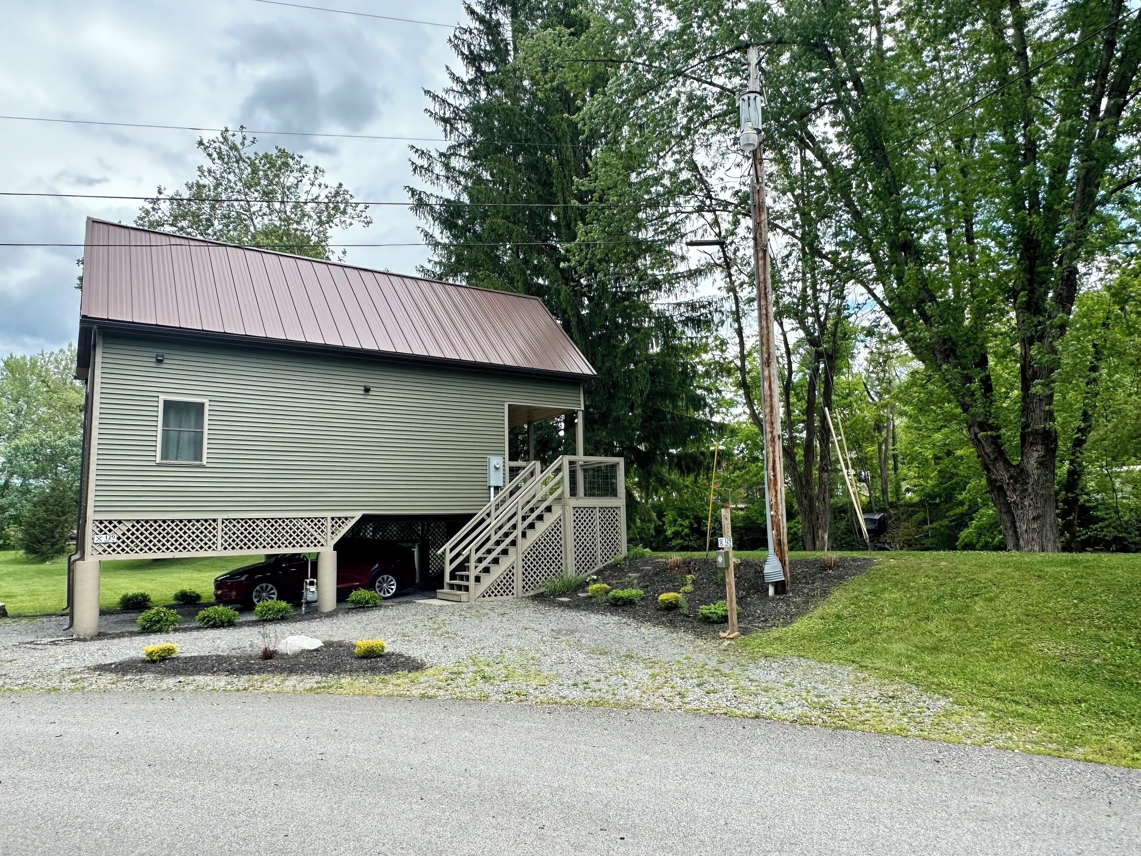 A single-story building with a metal roof and a covered garage.