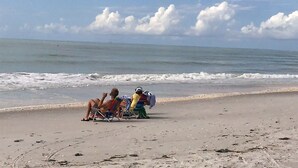 Eine Strandansicht mit sandigem Ufer und Meereswellen.