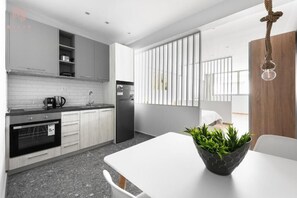 Enjoy cooking in this sleek kitchen with an oven, stainless steel sink, and ample natural light.