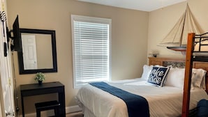 A bedroom with a bed, bedside table, and a window with blinds. - Lakefront Cabin : Boat Slip : Dock : Kayaks : Families : Internet (Jacksboro)