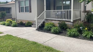 A single-story house with a front porch, a small set of steps, and a covered entryway. - Lakefront Cabin : Boat Slip : Dock : Kayaks : Families : Internet (Jacksboro)