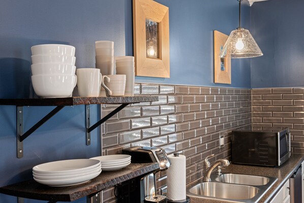 Fridge, microwave, coffee/tea maker, cookware/dishes/utensils