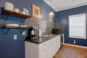 Fridge, microwave, coffee/tea maker, cookware/dishes/utensils