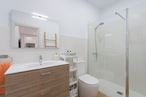 Regadera, secadora de cabello, toallas, papel de baño 