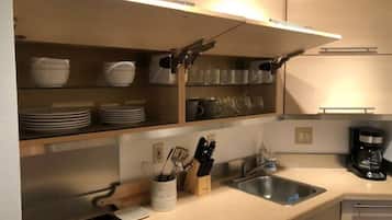 Fridge, microwave, coffee/tea maker, cookware/dishes/utensils