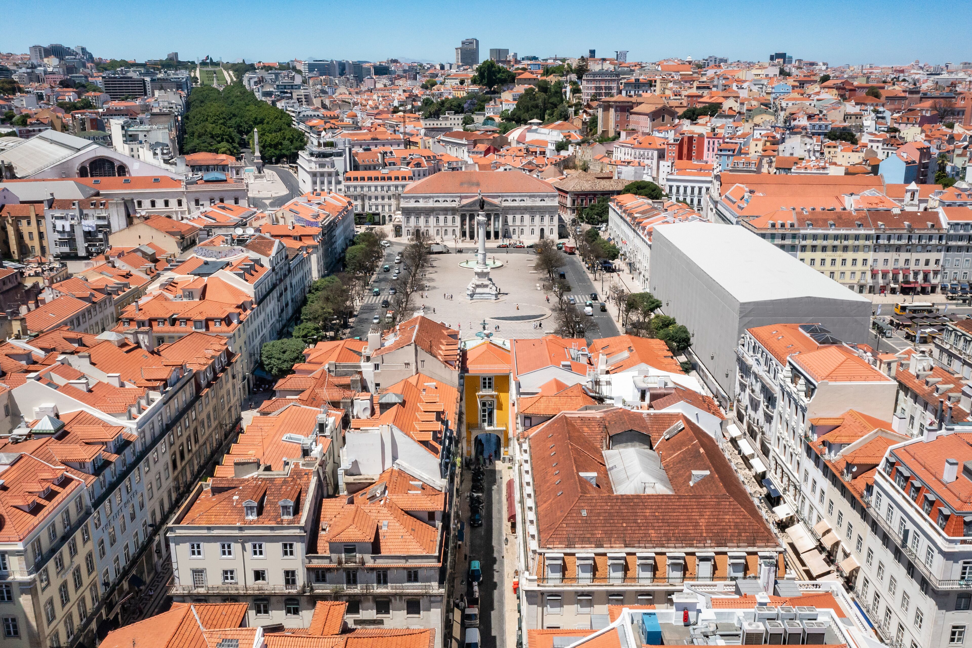 A cityscape with a prominent square, historic buildings, and a large white structure in the foreground.