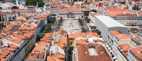 A cityscape with a prominent square, historic buildings, and a large white structure in the foreground.