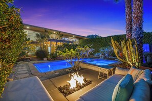 A backyard with a swimming pool, fire pit, and outdoor seating area. - Joplin House - Poolside Paradise w/ Amazing Views! (Palm Springs)