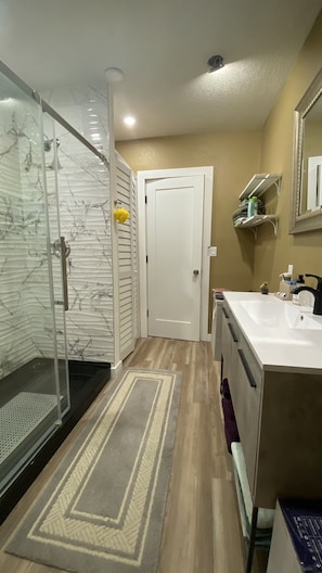 Shower, hair dryer, towels, toilet paper