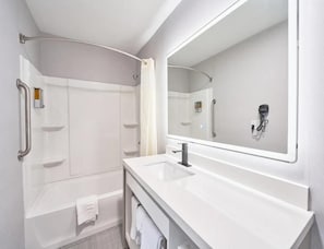 Bathtub, hair dryer, towels, soap