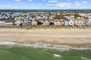 An aerial view of a coastal residential area with beachfront properties. - "Cast-a-waves" Make every day a Holiday! (Carolina Beach)