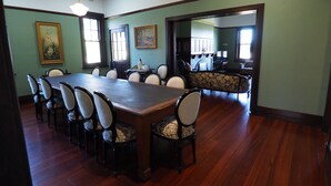 A dining room with a long wooden table surrounded by chairs, a fireplace, and framed artwork on the walls. - BALMORAL LODGE  - EXCLUSIVE COUNTRY ESCAPE (Cockatoo Valley)