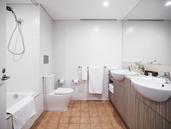 A modern bathroom with a shower, toilet, and sink. - Desert Gardens Hotel (Yulara)
