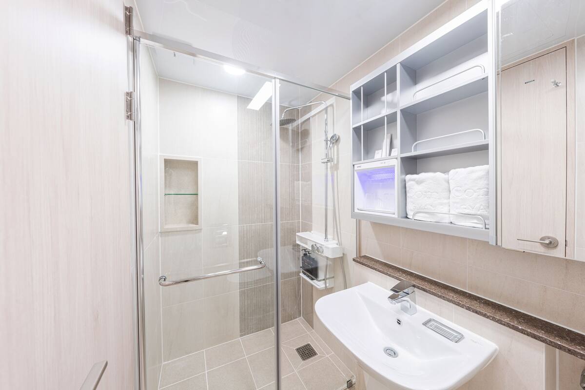 shower, rainfall showerhead, hair dryer, towels